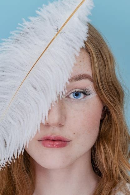 Premium Photo | Beautiful young woman with soft feather