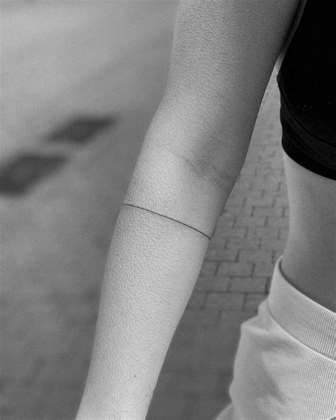 Line art armband tattoo done on the forearm.
