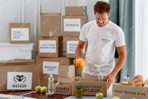 Premium PSD | Male volunteer preparing donation box with provisions