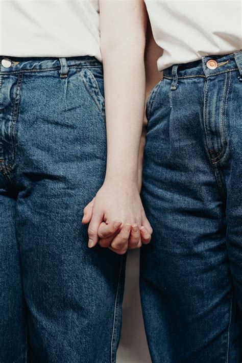 Persons Wearing Denim Jeans While Holding Hands · Free Stock Photo