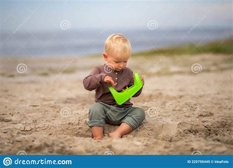 Cute Baby Playing in the Sand with Sand Toys on the Beach Stock Image ...
