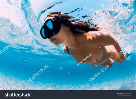 Стоковая фотография 1492617470: Naked Woman Free Diver Glides Over 