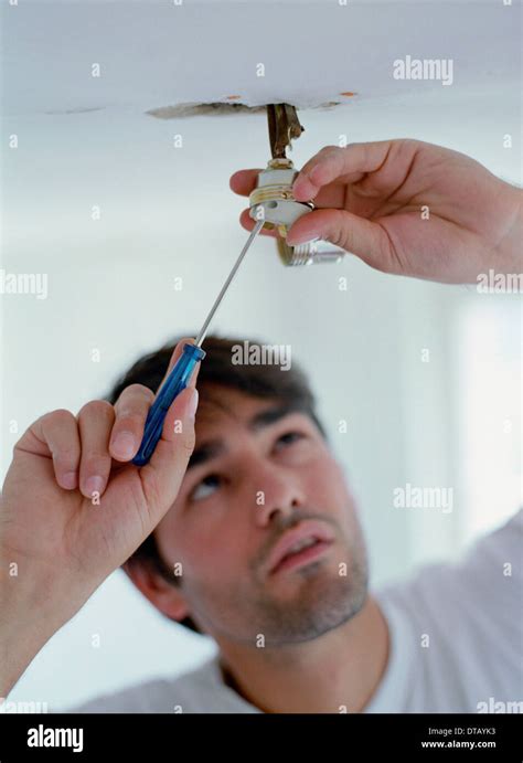 man fixing  light stock photo alamy