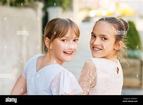 Outdoor portrait of two sweet kid girls wearing party dresses Stock ...
