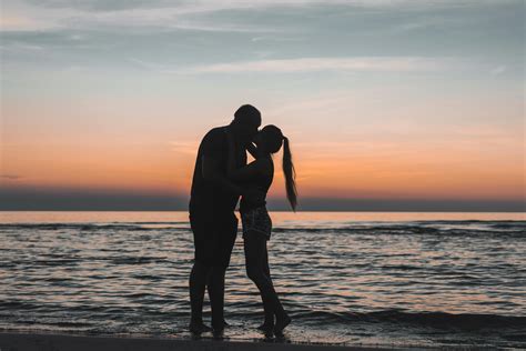 Man and Woman Kissing on Beach during Sunset · Free Stock Photo