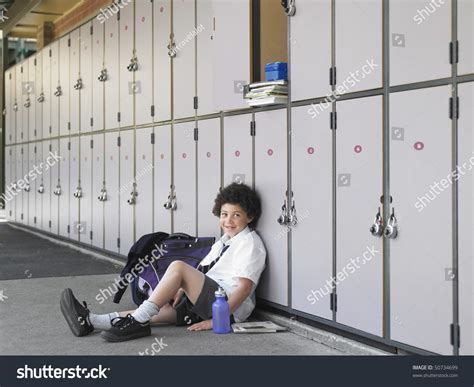 Elementary Schoolboy Sitting On Floor Against Stock Photo 50734699 ...