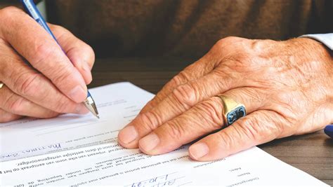 Person Signing in Documentation Paper · Free Stock Photo