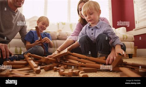 Young boy disassembling wooden play house Stock Photo - Alamy