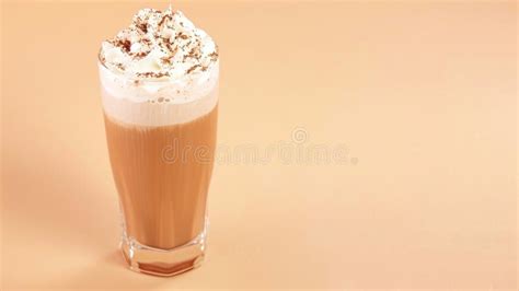 glass  whipped cream topped iced coffee frappe   light beige