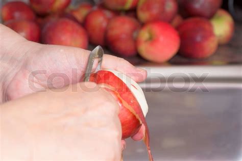 Peeling a red apple | Stock image | Colourbox
