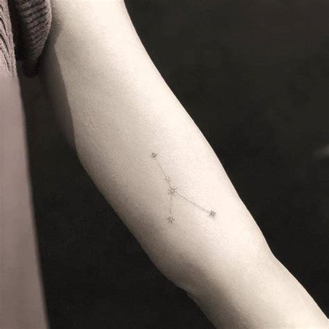 Cancer constellation tattoo on the left inner arm.