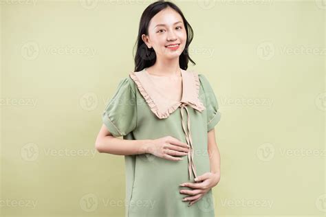 Pregnant Asian woman feeling happy and looking forward to giving birth