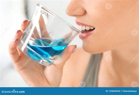 woman rinsing mouth  mouthwash stock photo image  cavity