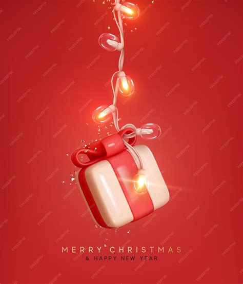 Рождественская коробка с подарками, висящая на яркой светящейся Xmas ...