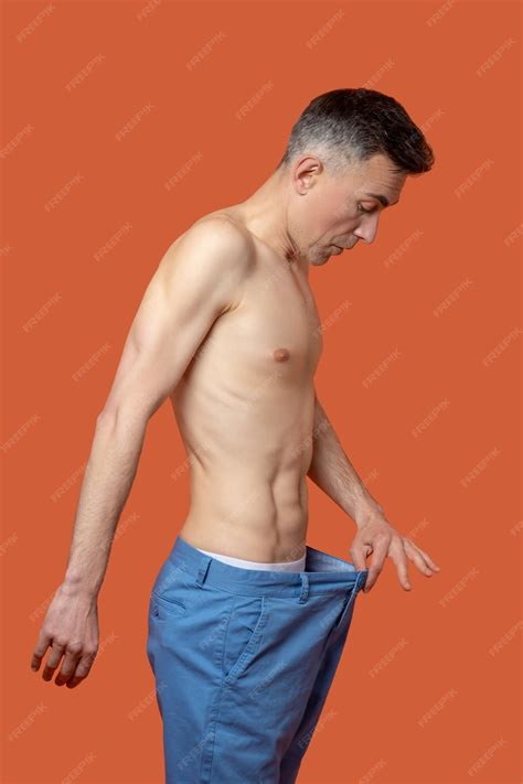 Premium Photo | Lose weight. A man looking to his belly and and feeling
