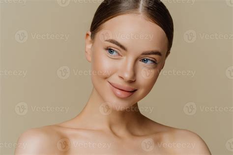 Portrait of thoughtful dreamy half naked woman looks aside with