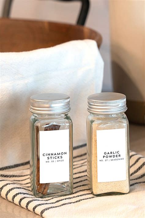 two jars filled with spices sitting on top of a towel