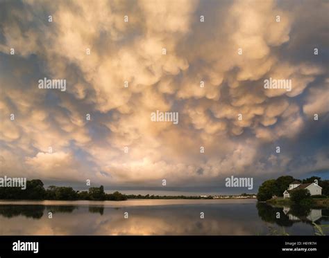 Stunning mammatus clouds formation over lake landscape immediately ...