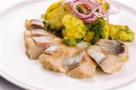 Premium Photo | Salted fish with boiled potato and pickled onions