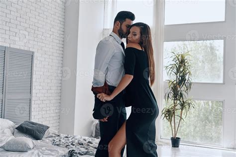 No rules for them. Beautiful young woman undressing her boyfriend while