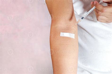 hand holding injection  showing injection marks  stock photo