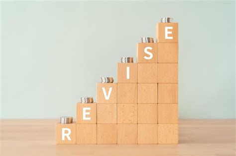 Premium Photo | Wooden blocks with revise text of concept and coins.