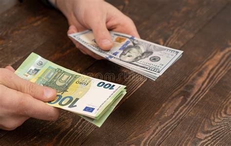 Choice - Dollars or Euros, Exchange Dollars To Euro Money in Male Hand ...