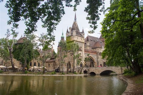 Vajdahunyad Castle with lake in daylight - Hungary Photo Tours