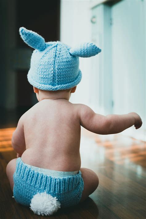 A Baby in a Blue Bunny Costume Sitting on the Floor · Free Stock Photo