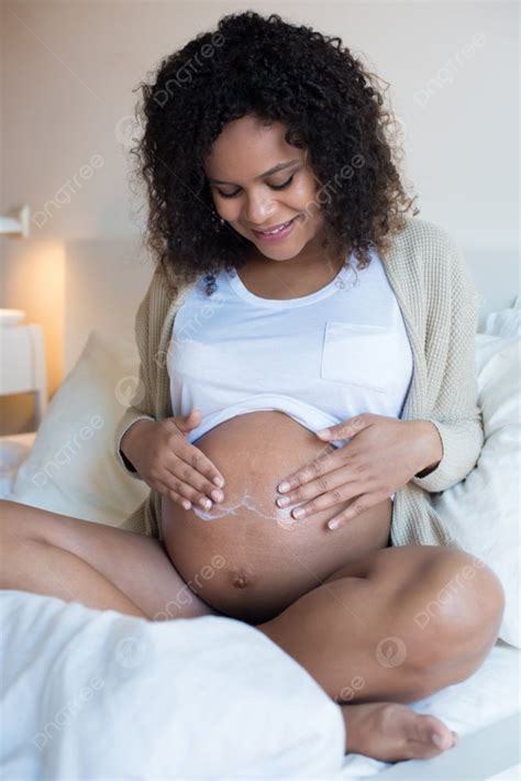 African Pregnant Woman Moisturizing Her Belly Photo Background And