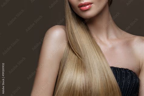 Beautiful blond girl with a perfectly smooth hair, classic make-up ...
