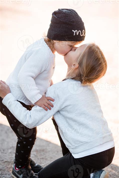 Little sisters kissing 20470650 Stock Photo at Vecteezy