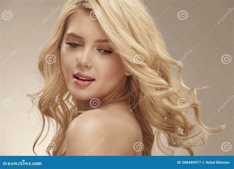 pretty young blonde woman  nude makeup   curly long bright hair