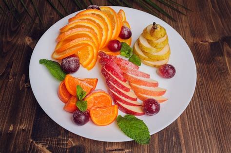 premium photo assortment  sliced fruits  plate  drops