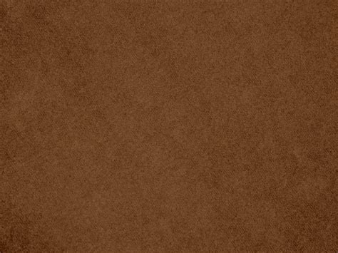 Brown color velvet fabric texture used as background. Empty brown