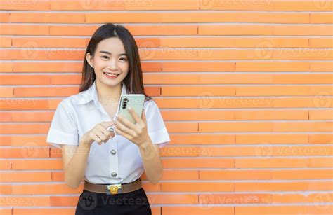 Portrait young Asian beautiful and pretty Thai girl student in uniform
