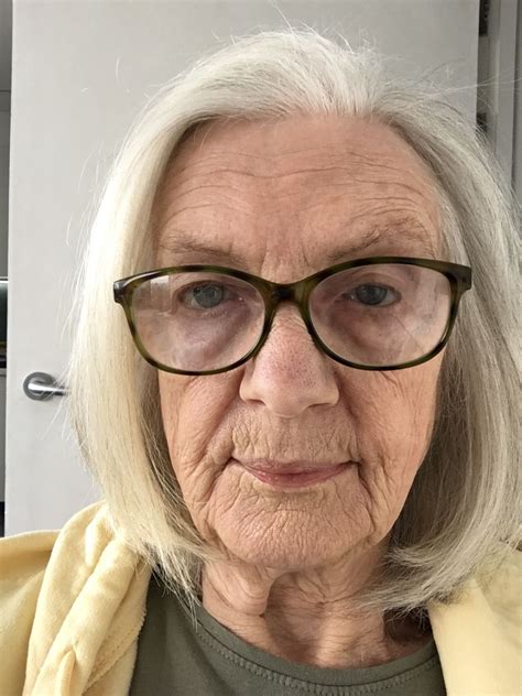 an older woman with glasses looking at the camera
