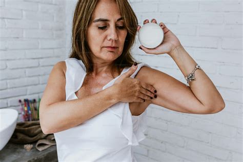 Hispanic senior middle aged woman after shower using antiperspirant or