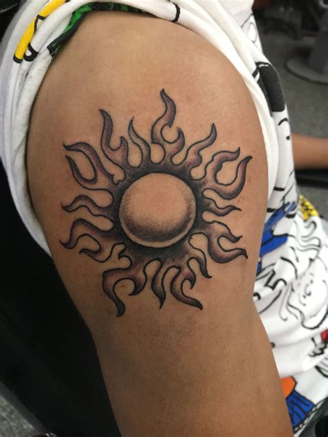 sun on shoulder tattoo