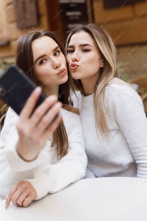 Premium Photo | Girlfriends taking selfies with the phone