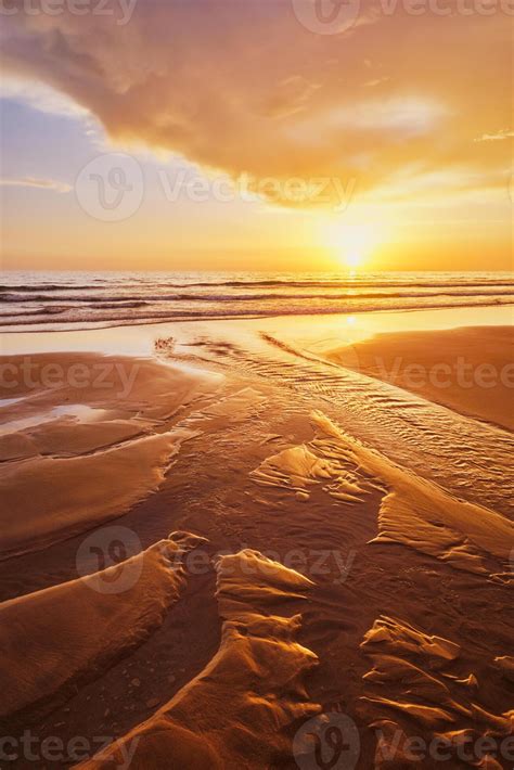 Atlantic ocean sunset with surging waves at Fonte da Telha beach