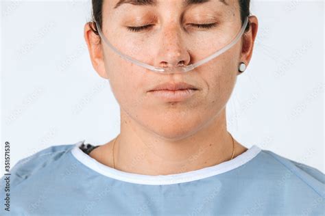 Sick female patient with a nasal cannula Stock Photo | Adobe Stock