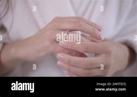 Close-up slim female Caucasian young hands touching engagement ring on ...