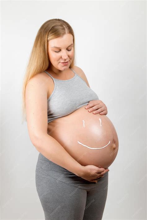 Premium Photo | Cream on the stomach of a pregnant girl in the form of