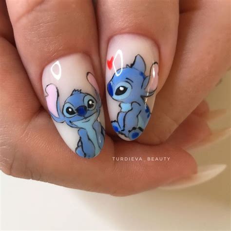 someone is holding up their nails with the nail art on them