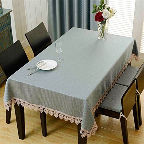 a dining room table covered with a light blue tablecloth