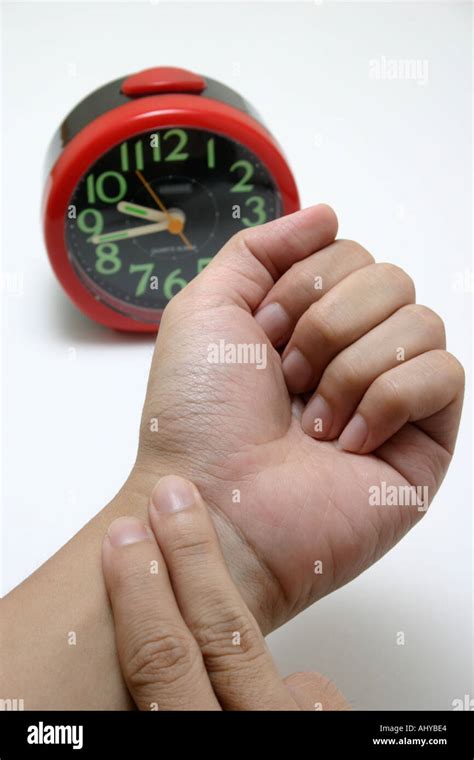 fingers taking pulse to measure heartbeat rate with clock Healthcare ...