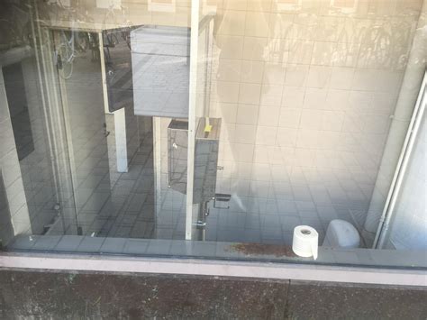 This toilet is completely visible from the street in the middle of the