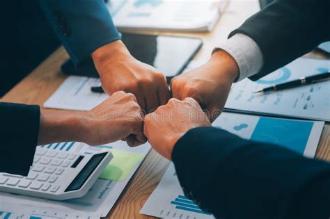 business people join hands  join forces   teamwork stock photo
