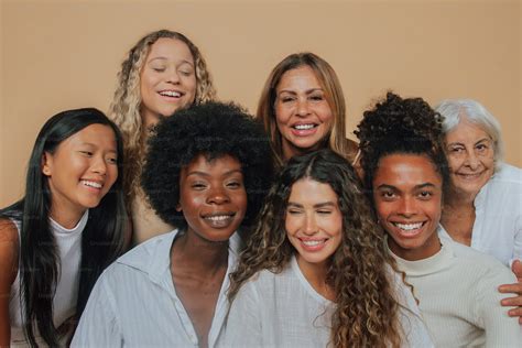 A group of women standing next to each other photo – Women Image on